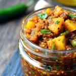 Spicy Pineapple Jalapeño Chutney served in a bowl with fresh pineapple and jalapeños