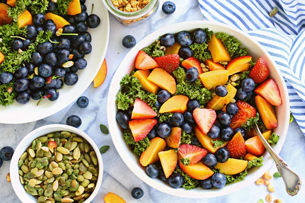 Fresh summer peach and blueberry kale salad in a bowl
