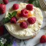 A slice of creamy sugar free keto cheesecake topped with fresh berries on a white plate