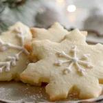 A beautifully decorated cut out sugar cookie in various shapes, including stars and hearts, with colorful icing and sprinkles.