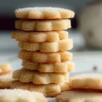 A plate of freshly baked sugar cookies decorated with colorful icing and sprinkles