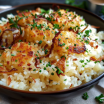 A bowl of buttery onion rice delight garnished with fresh herbs and served with a side of vegetables