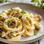 A bowl of caramelized creamy leek pasta garnished with fresh herbs and grated cheese
