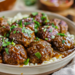 A plate of savory Salisbury steak meatballs garnished with parsley and served with mashed potatoes and gravy.