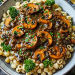 A creamy lentil mushroom stroganoff served in a white bowl garnished with fresh parsley