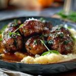 Delicious Salisbury steak meatballs garnished with fresh parsley and served with creamy gravy on a white plate