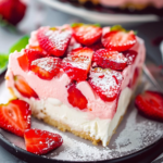 A delicious strawberry poke cake topped with fresh strawberries and whipped cream
